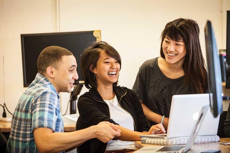Photo of 3 students in a classroom