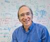 Photo of man smiling in front of whiteboard